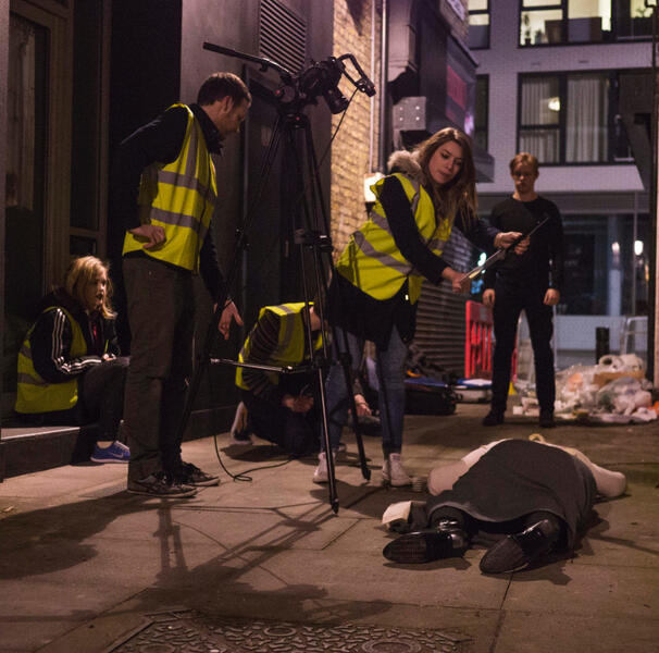 Tracy lying on a cold pavement filming Ginger, directed by Selina Sondermann.